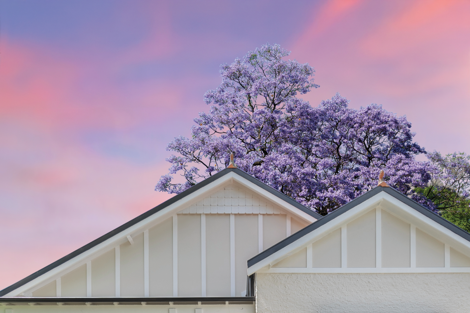 Plane flying over a house at sunset