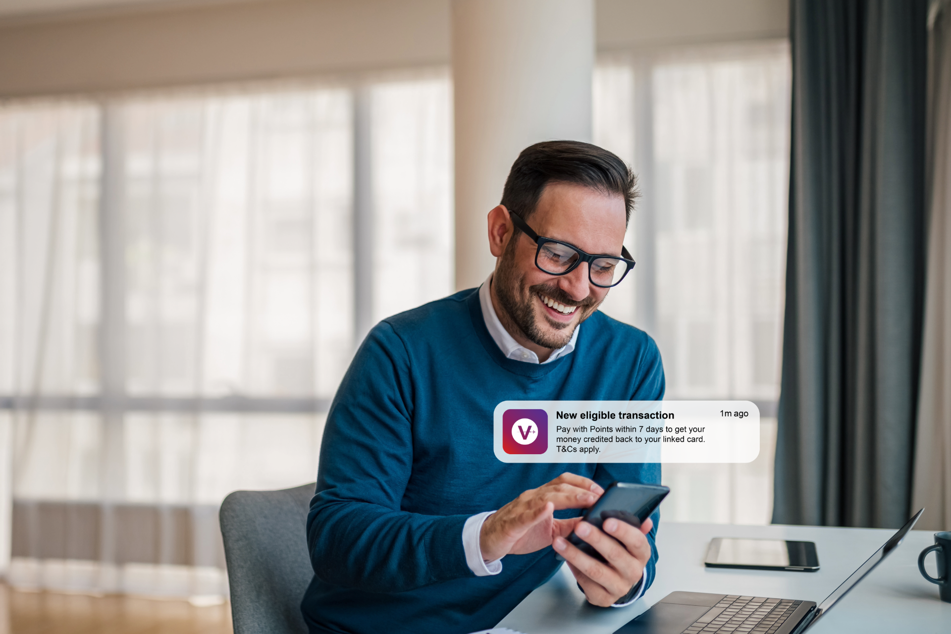 Image of person holding phone with notification pop-up